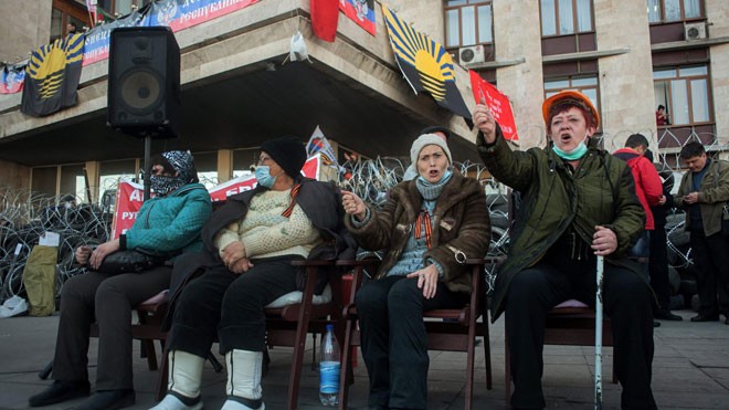 Những người ủng hộ Nga tập trung bên ngoài tòa nhà chính quyền được quây bằng dây thép và lốp xe ở Donetsk. Ảnh: Guardian