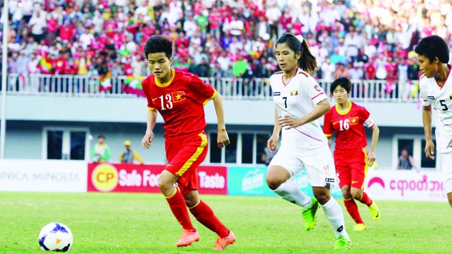 Các cô gái Việt Nam (đỏ) sẽ chịu sự cạnh tranh quyết liệt từ những đối thủ trong khu vực là Myanmar (trắng) và Thái Lan để giành vé thứ 5 dự World Cup 2015. ảnh: T.Vũ 