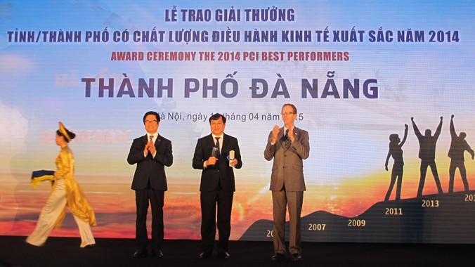 Ông Huỳnh Đức Thơ, Chủ tịch TP Đà Nẵng (ở giữa) nhận kỷ niệm chương cho giải thưởng địa phương có chất lượng điều hành kinh tế xuất sắc năm 2014. Ảnh: Phạm Anh.