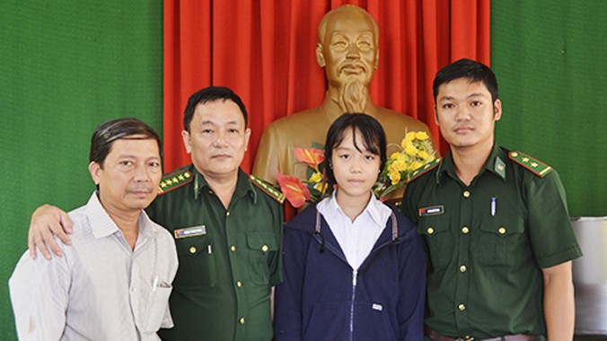 Trung úy Lương Sơn Trung (ngoài cùng bên phải) bên gia đình nữ sinh Hồ Lê Thảo Nguyên. Ảnh: Vũ Tiến.