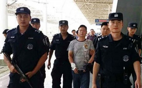 Một đối tượng bị cảnh sát Trung Quốc áp giải trong chiến dịch truy quét toàn quốc. Ảnh: SMCP.