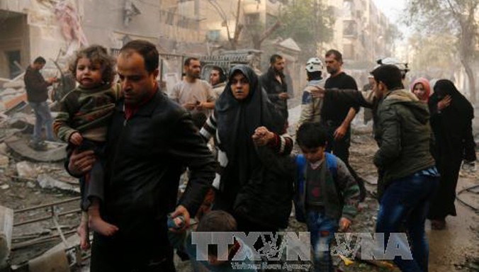 Người dân Syria sơ tán sau các cuộc không kích của quân đội chính phủ vào các mục tiêu của phiến quân ở thành phố Aleppo ngày 13/1. Ảnh: AFP/TTXVN.