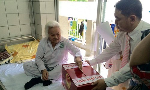 Cụ Nguyễn Thị Nga sinh năm 1937, Thanh Trì, Hoàng Mai, Hà Nội) bị thoái hóa khớp bỏ phiếu tại Hòm phiếu di động khoa Cơ xương khớp, BV Bạch Mai (Hà Nội).