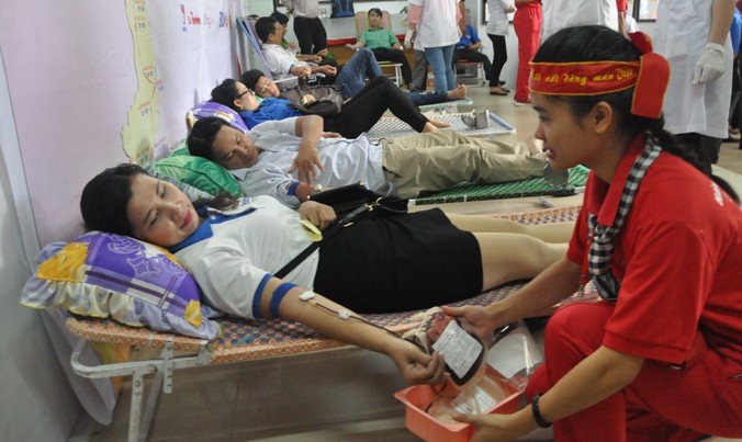 Tình nguyện viên Tạ Thị Ngọc Diệp đang trò chuyện với một người hiến máu.