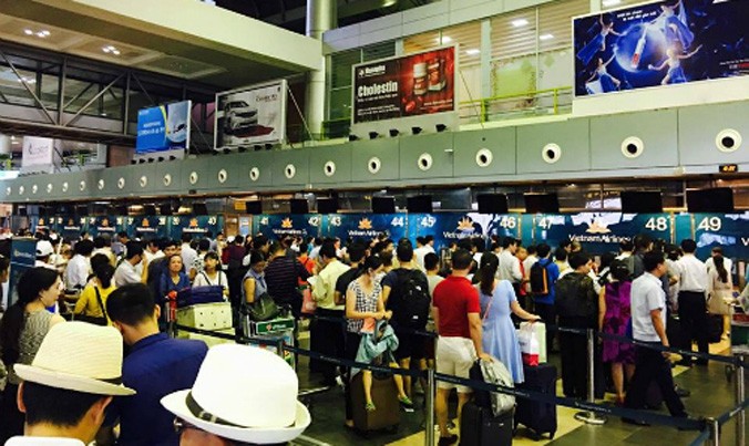Các màn hình thông báo ở sân bay Nội Bài chiều qua bị tắt. Hành khách dồn ứ vì chưa thể làm thủ tục bay. Ảnh: Hùng Sơn.