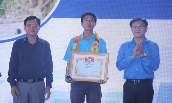 Anh Lâm Đình Thắng (bìa phải), Phó bí thư thường trực Thành Đoàn TP, trao bằng khen của Thành Đoàn cho các thanh niên nông thôn làm kinh tế giỏi năm 2016.