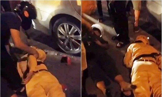 Hình ảnh hai cảnh sát bất tỉnh sau khi ngã ra đường. Ảnh cắt từ clip.