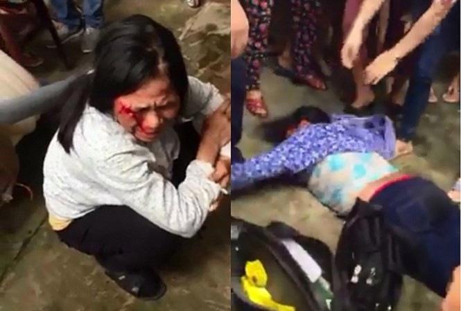 Hai người phụ nữ nghi bắt cóc trẻ em đã bị người dân giữ lại và hành hung. Ảnh cắt từ clip.