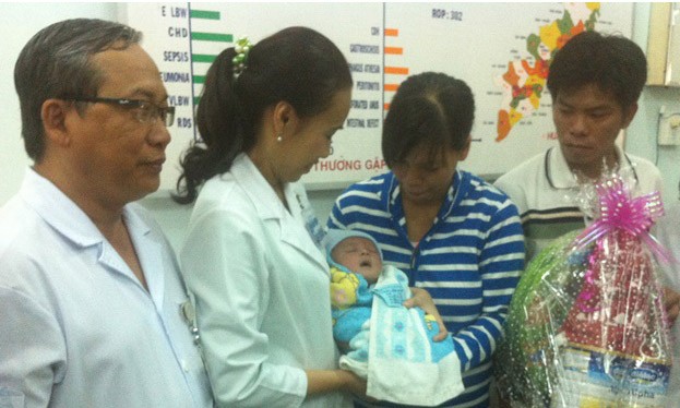 Các bác sĩ trao bé Phát cho gia đình.