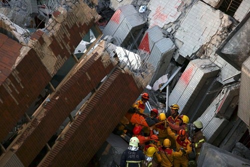 Nhân viên cứu hộ đưa một người sống sót ra khỏi đống đổ nát sau trận động đất ở Đài Loan. Ảnh: Reuters 