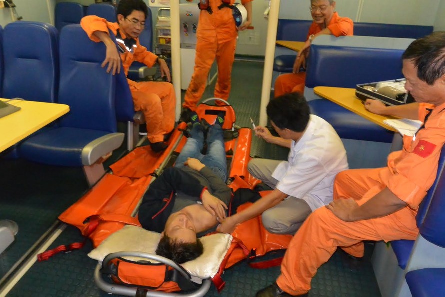 Lực lượng cứu nạn của Trung tâm II cùng nhân viên y tế chăm sóc sức khỏe cho một ngư dân gặp nạn trên biển. 