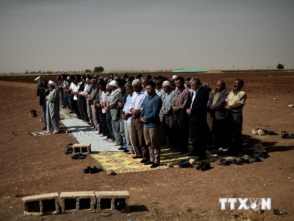 Người Kurd ở Thổ Nhĩ Kỳ và Syria cầu nguyện tại khu vực ngoại ô Suruc, tỉnh Sanliurfa (Thổ Nhĩ Kỳ) gần thị trấn Kobani ngày 10/10. (Nguồn: AFP/TTXVN)