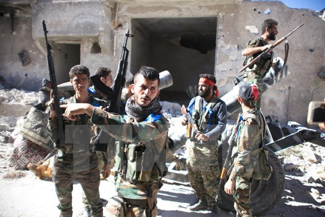 Binh sỹ quân đội Chính phủ Syria sau khi giành lại quyền kiểm soát doanh trại Handarat tại thành phố Aleppo ngày 25/9. (Nguồn: AFP/TTXVN)