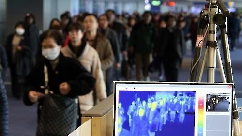 Hành khách đi qua một cảm biến kiểm tra sốt tại sân bay quốc tế Incheon, phía tây Seoul.