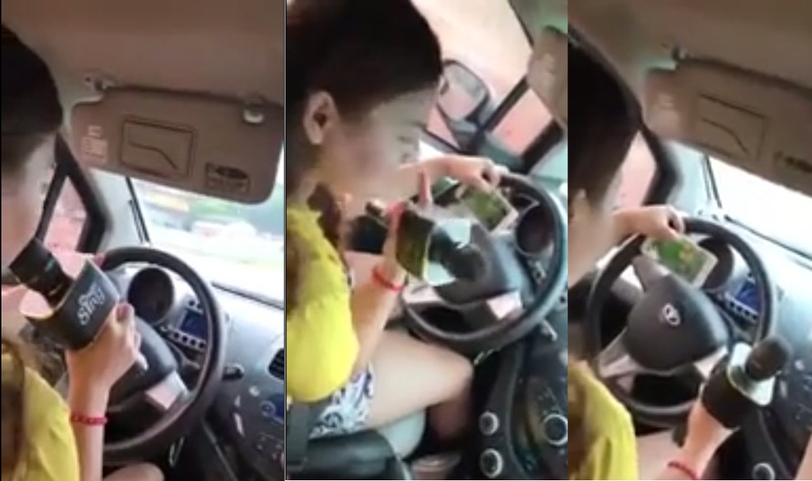 Cô gái vừa lái xe, vừa hát và chơi game. Ảnh cắt từ clip